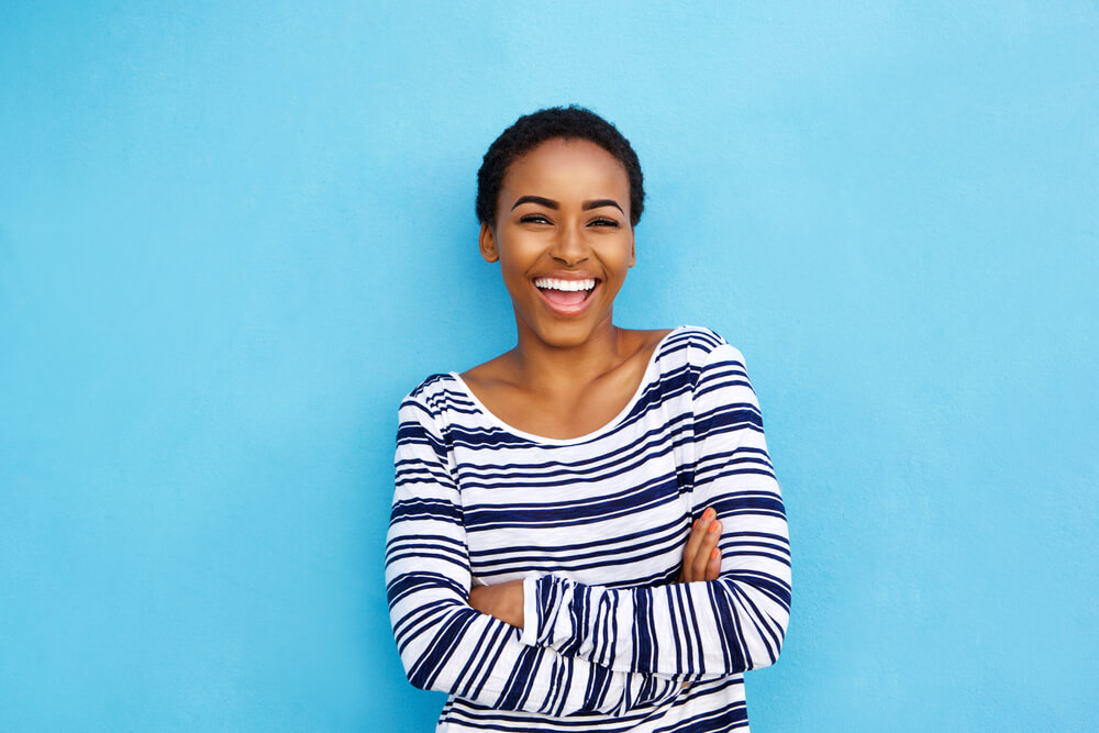 Young woman smiling with her arms crossed