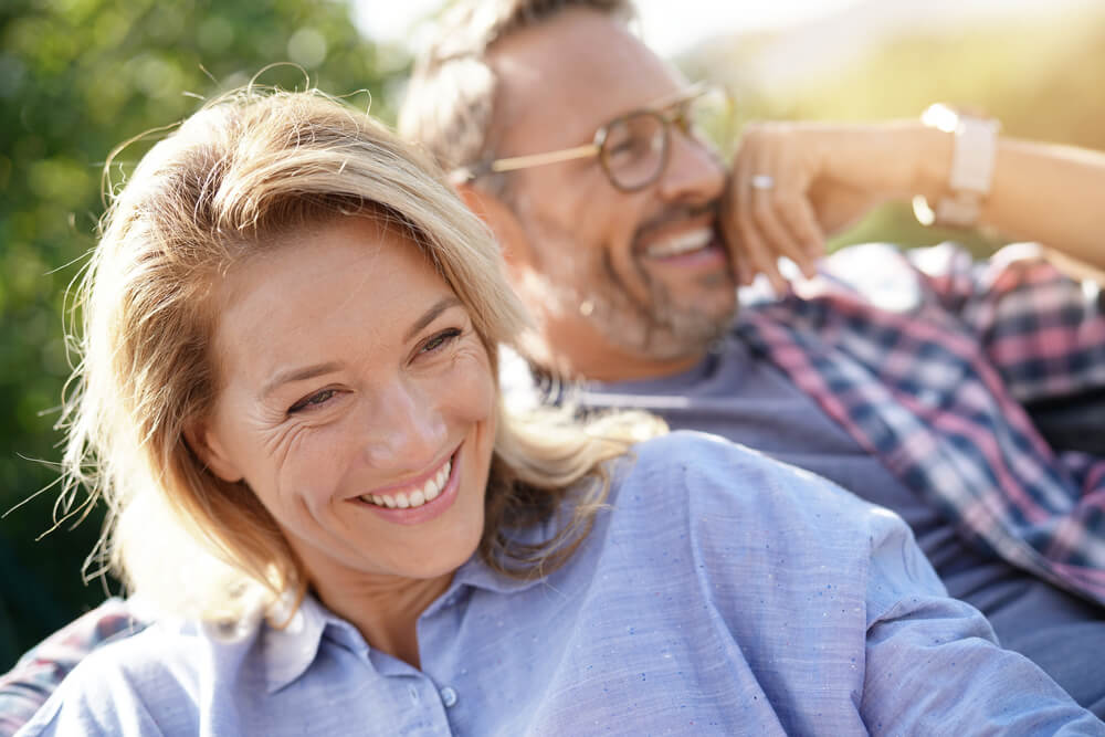 Middle-aged couple smiling outdoors